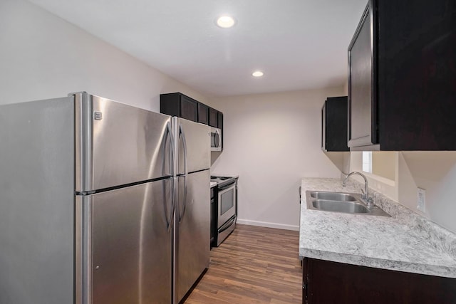 1312 Lafayette Ave, Kalamazoo, MI 49006 - kitchen featuring a sink, dark wood finished floors, light countertops, appliances with stainless steel finishes, and recessed lighting