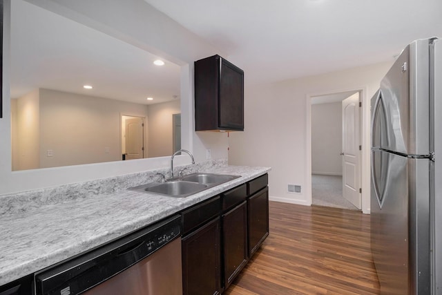 1312 Lafayette Ave, Kalamazoo, MI 49006 - kitchen featuring a sink, stainless steel appliances, dark wood finished floors, visible vents, and light countertops