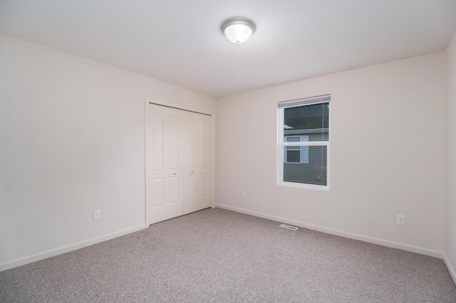 1312 Lafayette Ave, Kalamazoo, MI 49006 - unfurnished bedroom featuring carpet flooring, baseboards, and a closet