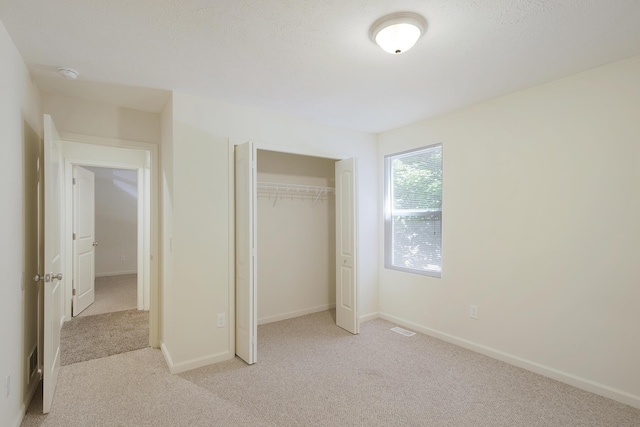 1312 Lafayette Ave, Kalamazoo, MI 49006 - unfurnished bedroom with light colored carpet, a closet, baseboards, and visible vents
