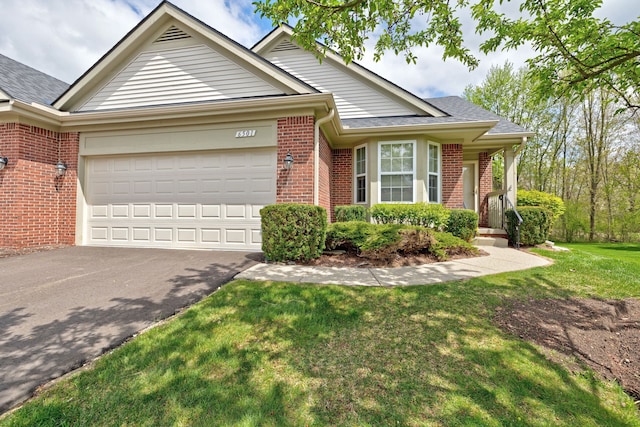 single story home featuring an attached garage, brick siding, driveway, and a front lawn