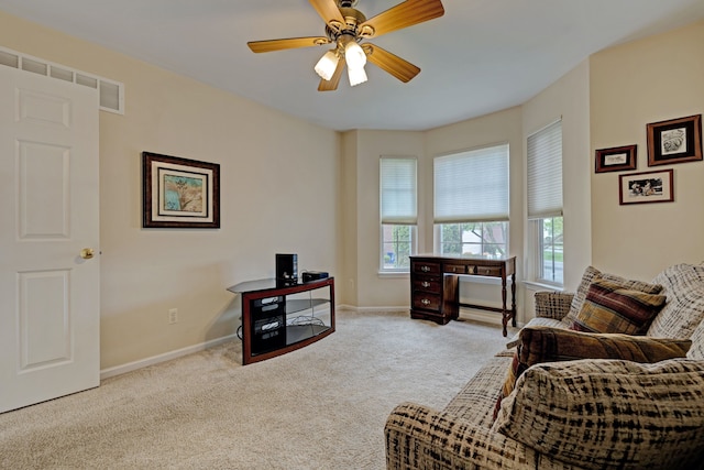interior space featuring baseboards, carpet flooring, visible vents, and ceiling fan