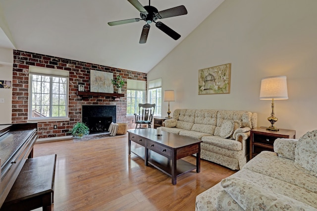 living room featuring ceiling fan, a wealth of natural light, high vaulted ceiling, and wood finished floors