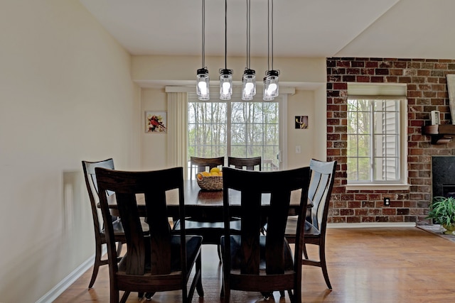 dining area with baseboards and wood finished floors