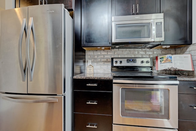 kitchen featuring stone counters, appliances with stainless steel finishes, dark brown cabinets, and backsplash
