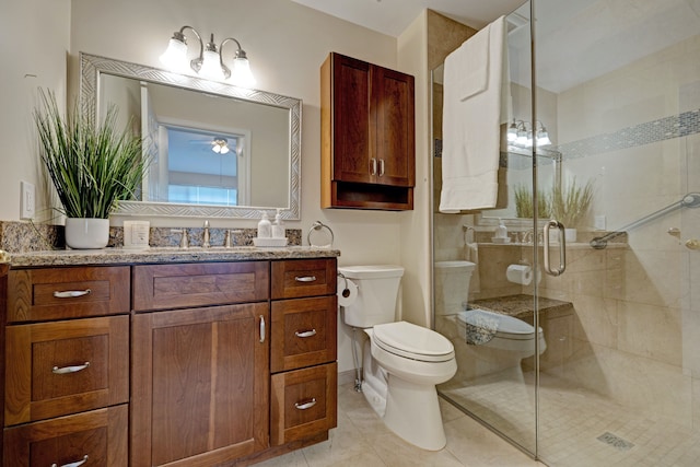 full bathroom with toilet, vanity, tile patterned floors, a stall shower, and ceiling fan