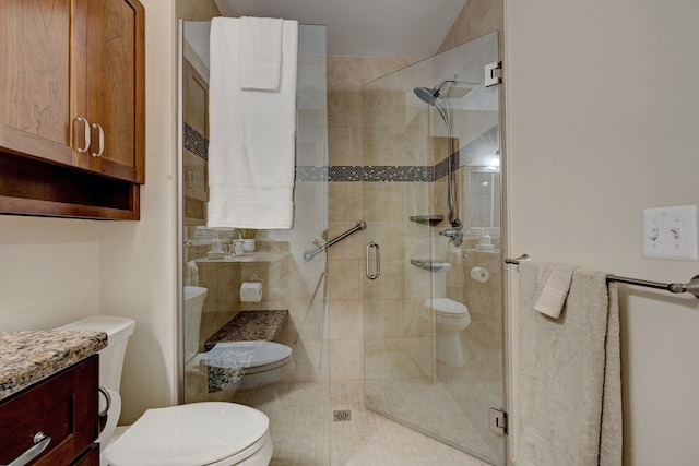full bathroom with vanity, toilet, and a shower stall