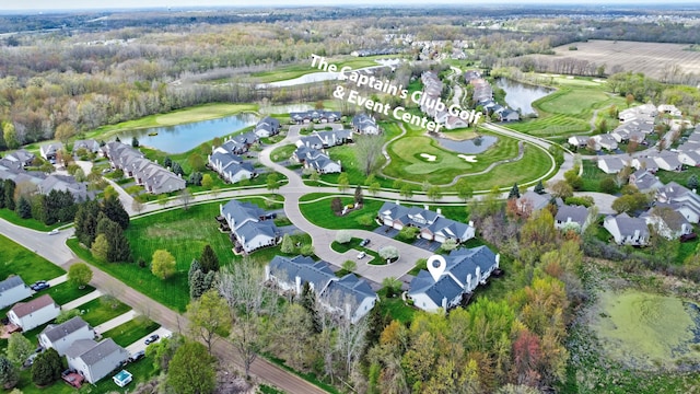 aerial view featuring view of golf course, a water view, and a residential view