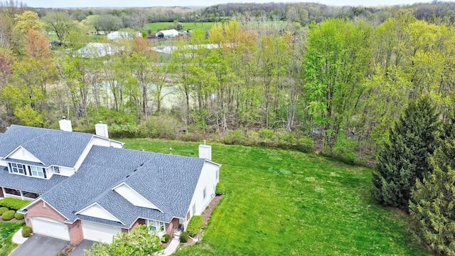 birds eye view of property featuring a wooded view
