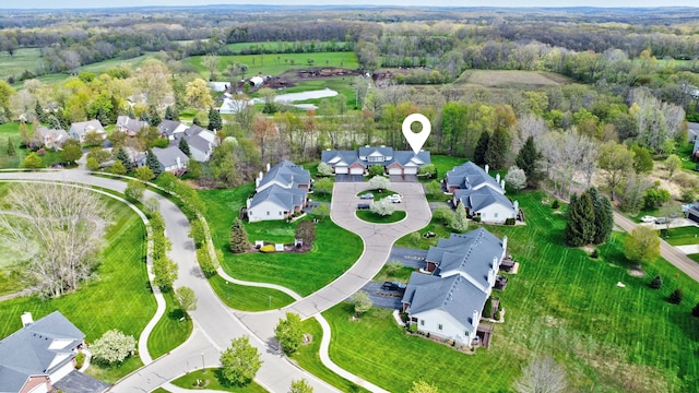 birds eye view of property featuring a forest view and a residential view