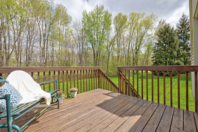 wooden terrace featuring a lawn
