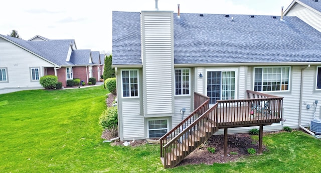 back of house with a yard, stairway, a wooden deck, a chimney, and a shingled roof