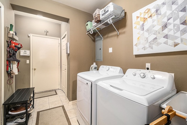 laundry room featuring light tile patterned floors, laundry area, and separate washer and dryer