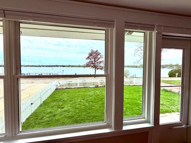 doorway to outside with a water view