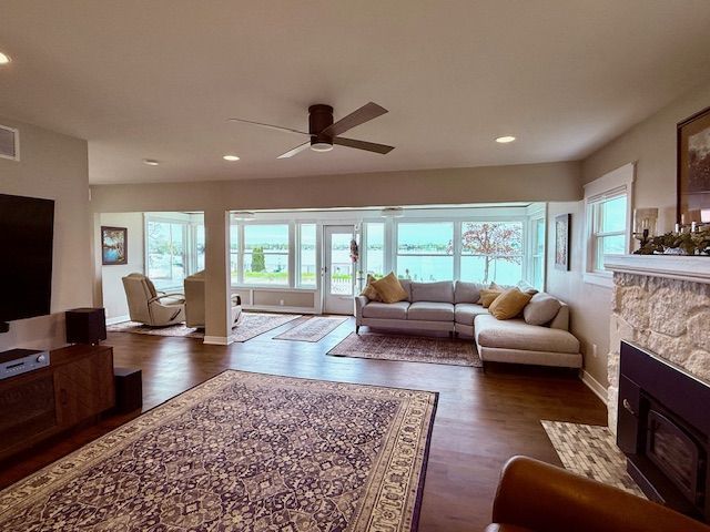 living area with a fireplace, dark wood-style flooring, a ceiling fan, and recessed lighting