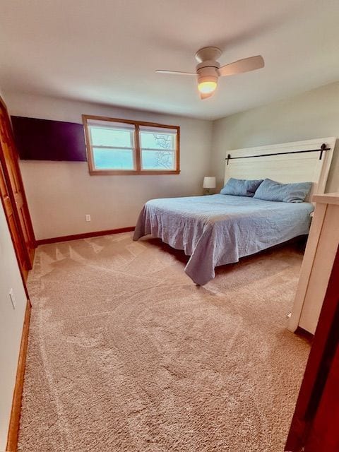 bedroom with baseboards, a ceiling fan, and carpet floors