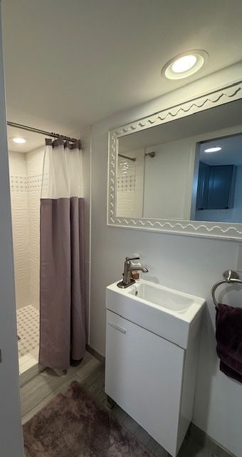 bathroom featuring vanity and a shower stall