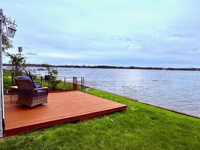 view of dock with a deck with water view