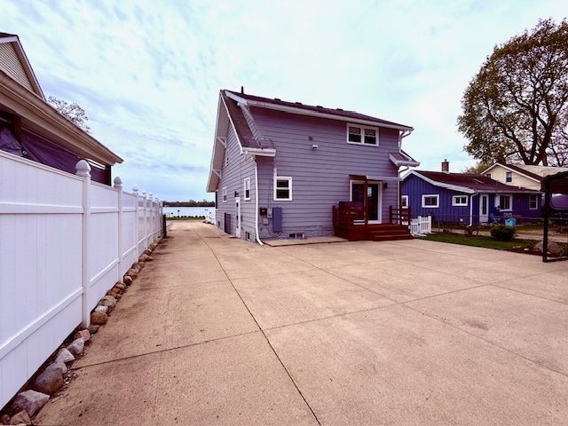 rear view of property with fence
