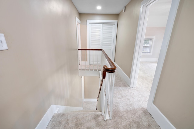 stairway featuring carpet and baseboards