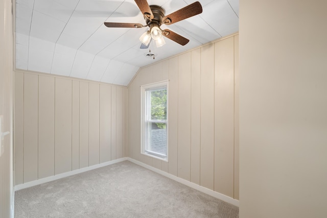 unfurnished room featuring lofted ceiling, a ceiling fan, and carpet