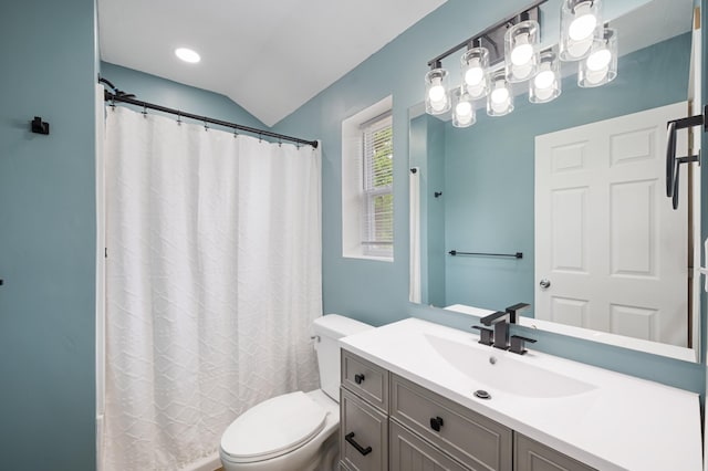 bathroom featuring curtained shower, vanity, toilet, and lofted ceiling