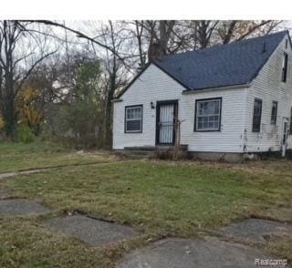 bungalow with a front lawn and a chimney