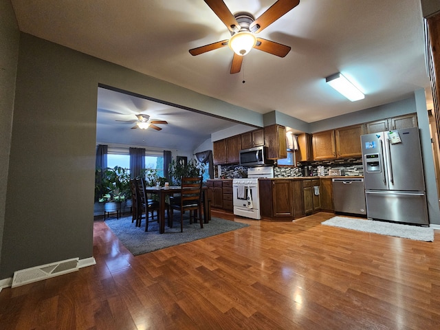 3544 Burnsline Rd, Brown City, MI 48416 - kitchen with stainless steel appliances, tasteful backsplash, wood finished floors, visible vents, and a ceiling fan