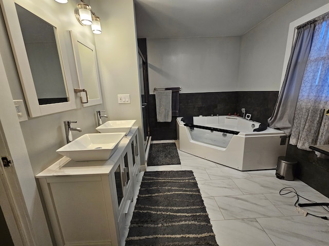 3544 Burnsline Rd, Brown City, MI 48416 - full bathroom with marble finish floor, a garden tub, double vanity, and a sink