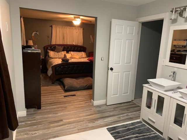 3544 Burnsline Rd, Brown City, MI 48416 - bedroom with a sink, baseboards, and light wood-style floors