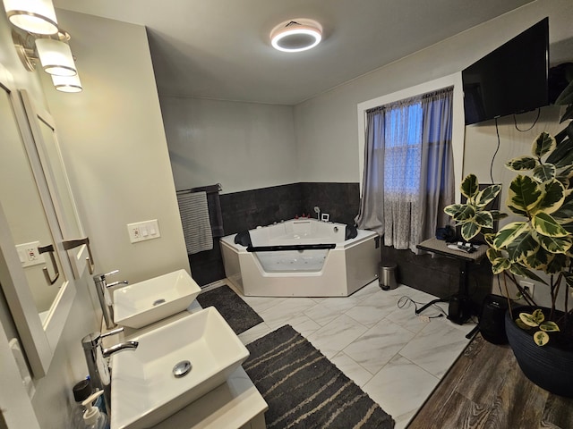 3544 Burnsline Rd, Brown City, MI 48416 - bathroom with wainscoting, a sink, a garden tub, and marble finish floor