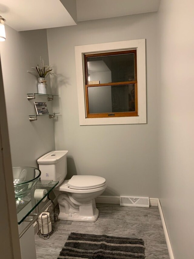 3544 Burnsline Rd, Brown City, MI 48416 - bathroom with baseboards, toilet, and visible vents