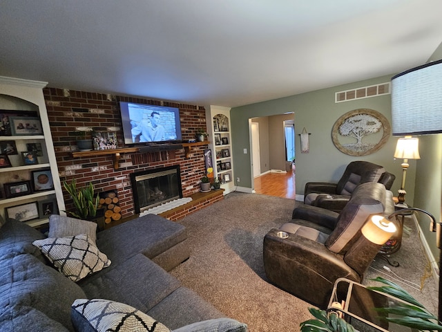 3544 Burnsline Rd, Brown City, MI 48416 - living room featuring carpet, visible vents, built in shelves, a brick fireplace, and baseboards