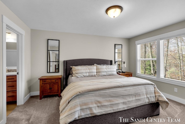 carpeted bedroom featuring baseboards
