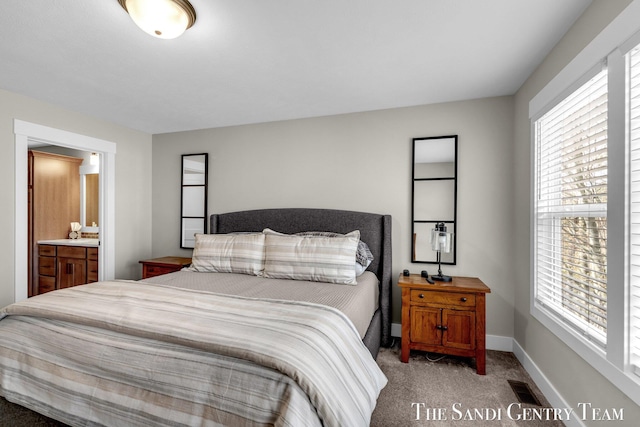 bedroom featuring baseboards, multiple windows, visible vents, and light colored carpet