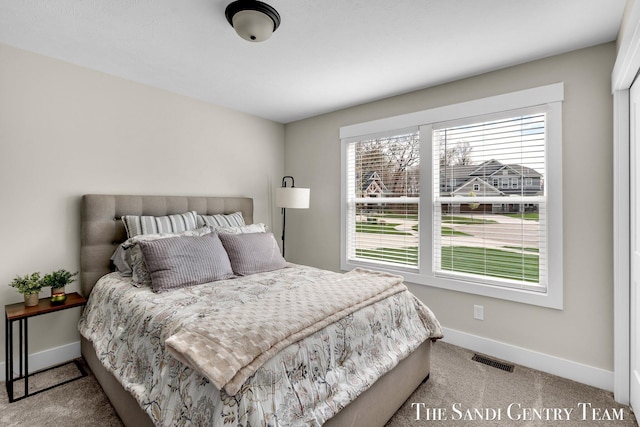 bedroom featuring baseboards, visible vents, and carpet floors