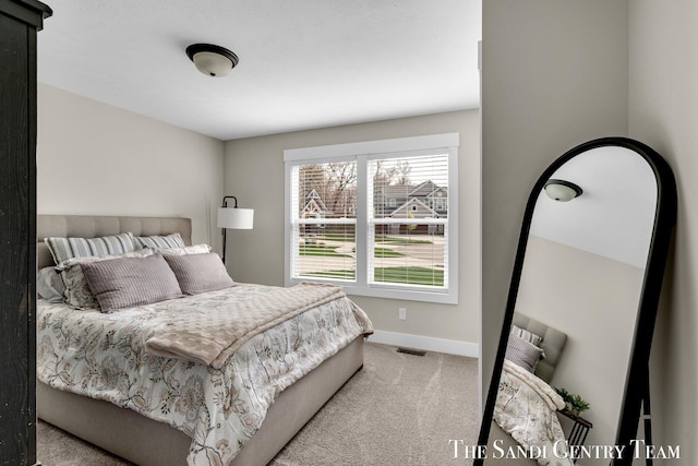 bedroom with carpet flooring, baseboards, and visible vents