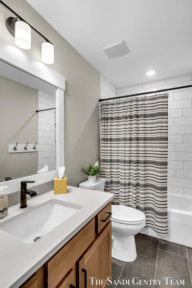 bathroom with shower / bath combo, toilet, visible vents, and vanity