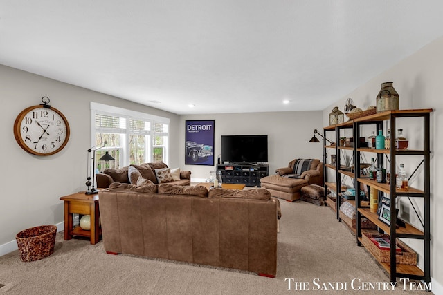 carpeted living area featuring baseboards and recessed lighting