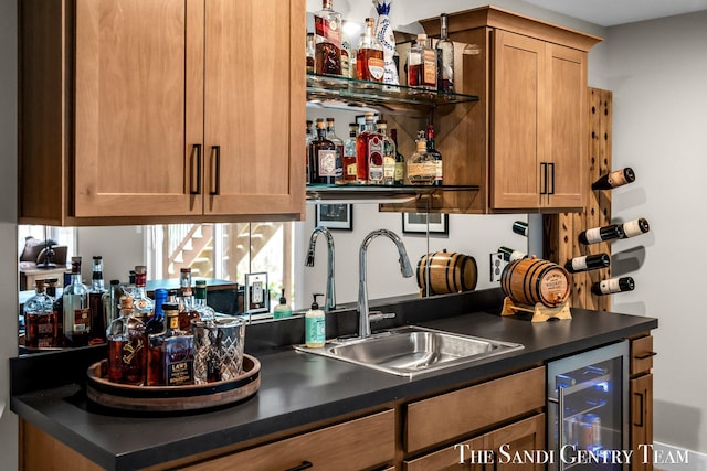 bar with wine cooler, wet bar, and a sink