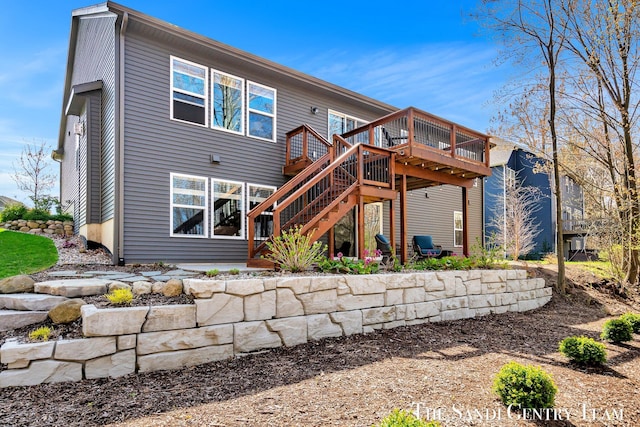 back of property with stairway and a wooden deck