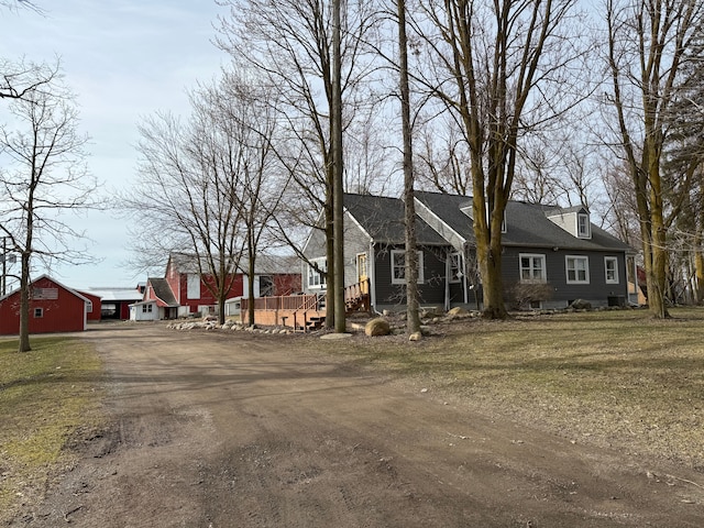 4131 Wellman Line Rd, Brown City, MI 48416 - cape cod-style house with driveway, a residential view, and roof with shingles