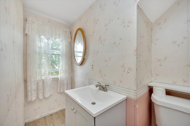4131 Wellman Line Rd, Brown City, MI 48416 - bathroom with wallpapered walls, vanity, wood finished floors, toilet, and lofted ceiling