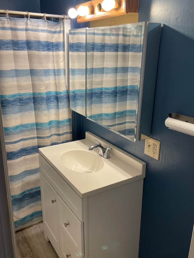 full bathroom featuring vanity and wood finished floors