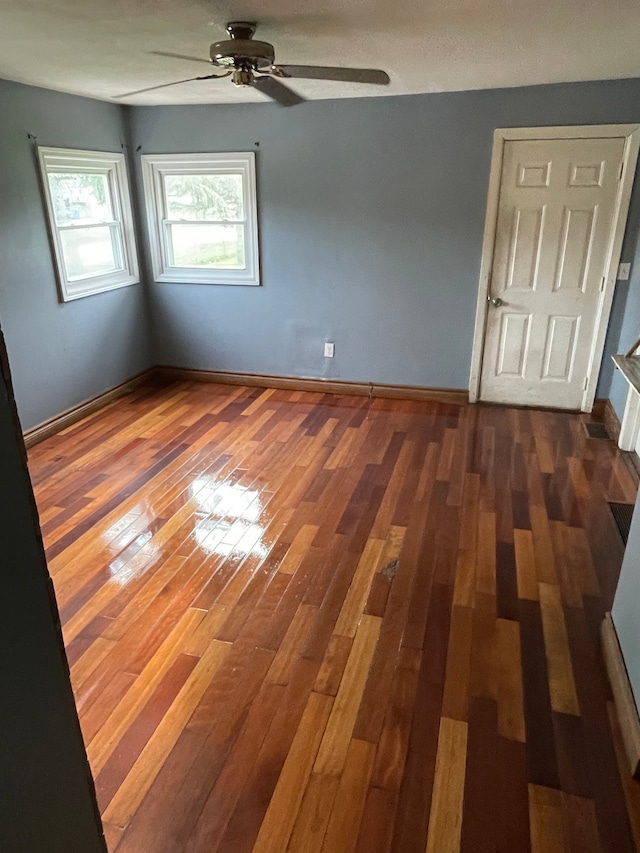 empty room featuring wood finished floors and ceiling fan