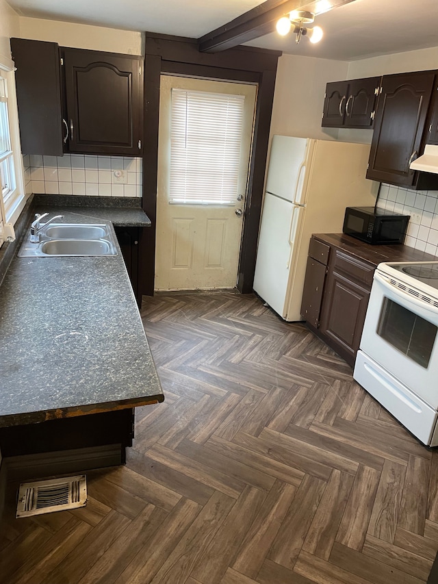 kitchen with white electric stove, dark countertops, visible vents, under cabinet range hood, and black microwave