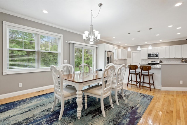 dining room featuring an inviting chandelier, light wood-style floors, crown molding, and recessed lighting