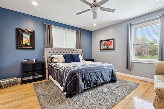 bedroom featuring wood finished floors, a ceiling fan, visible vents, baseboards, and recessed lighting