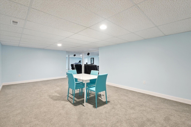 dining room featuring carpet flooring, baseboards, and a drop ceiling