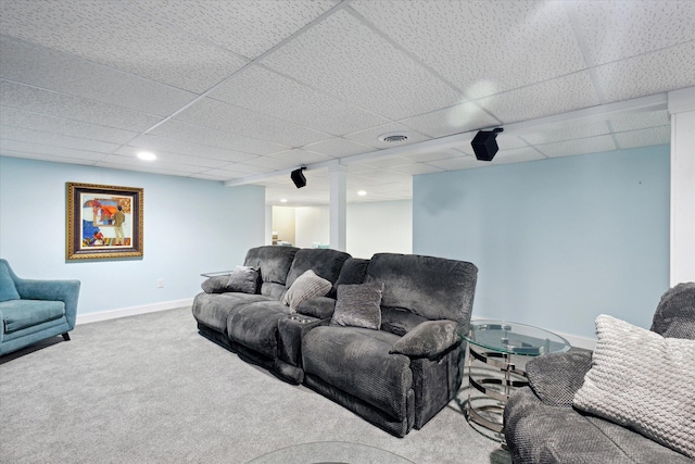 carpeted living room with baseboards, visible vents, and a drop ceiling
